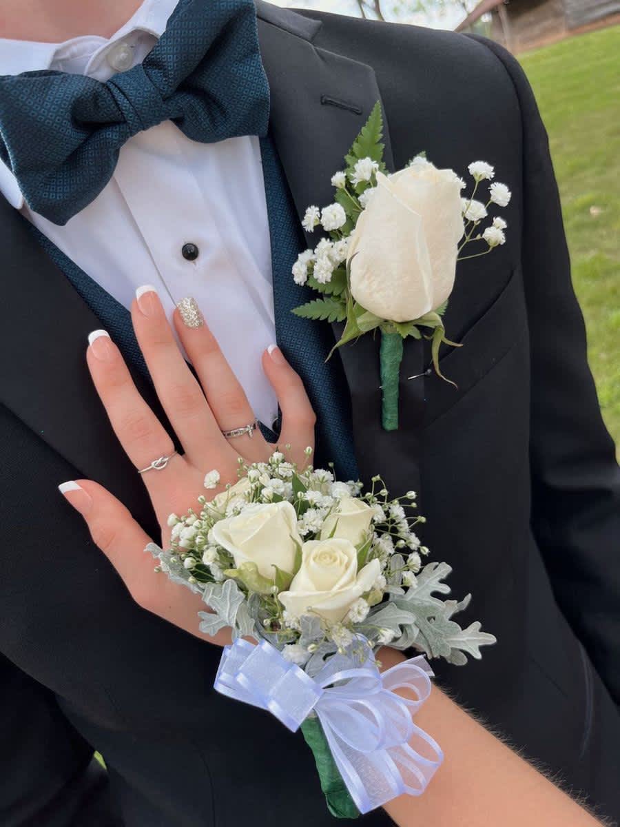 Corsage and Boutonnière white elegant set - A classic white boutonnière that compliments any suit. A perfect addition for any prom, formal, or wedding event. A classic white corsage with silver sheer ribbon, this wrist arrangement looks good with any outfit. A perfect compliment to any prom, formal, or wedding event.