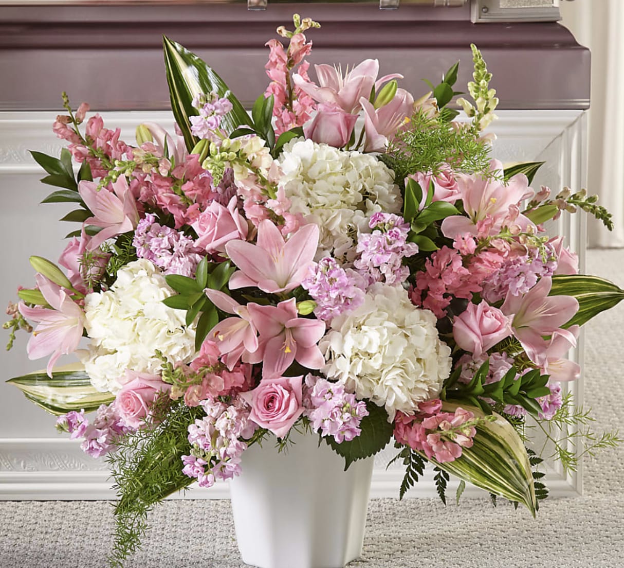 Gentle Embrace Tribute - Honor a cherished life with the timeless beauty of Gentle Embrace Tribute. Designed with fragrant pink lilies, lush white hydrangeas, elegant roses, and premium seasonal blooms, this abundant arrangement offers a comforting expression of love and remembrance. Handcrafted by the floral designers at Bloom Luxury Box, each piece is thoughtfully created to bring peace, warmth, and hope while celebrating a life that will never be forgotten.