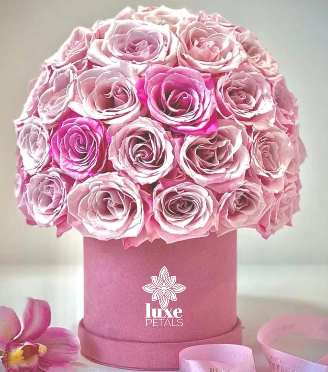Pink rose bouquet in a round pink box with a ribbon