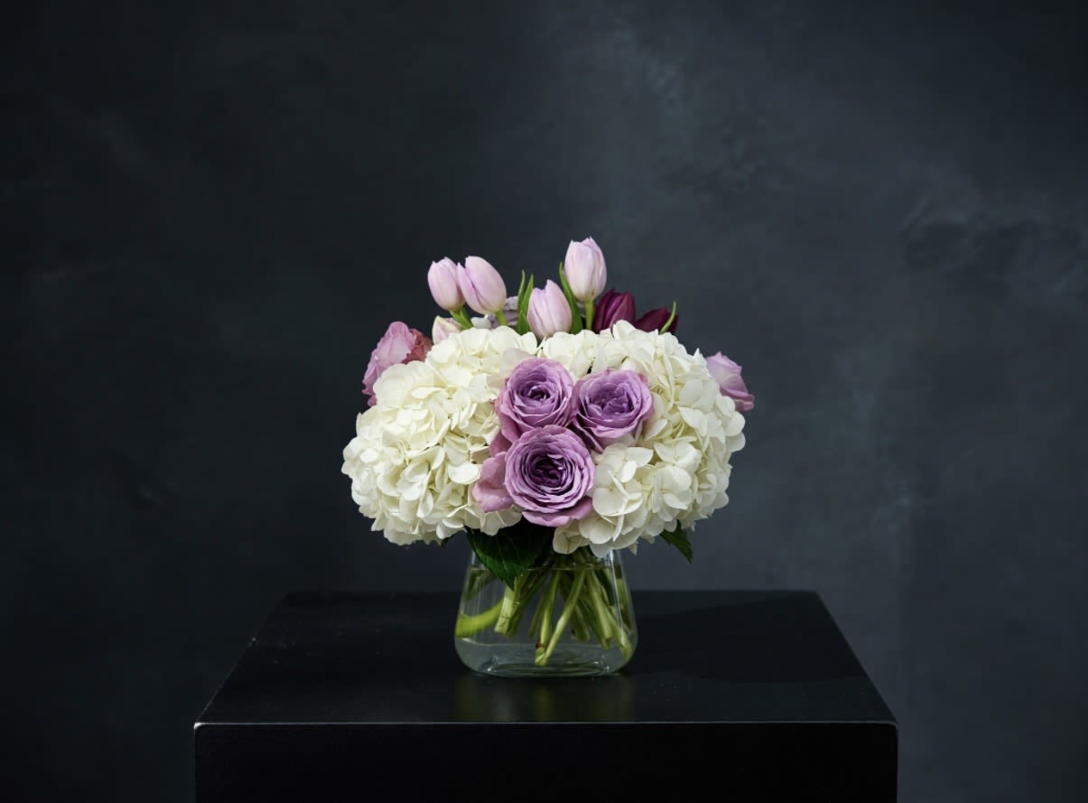 Here for You  - Express your condolences after the loss of a loved one with flowers. Sending this clean purple and white arrangement featuring lavender roses and white hydrangea is a way to show you care and are thinking of them.  
