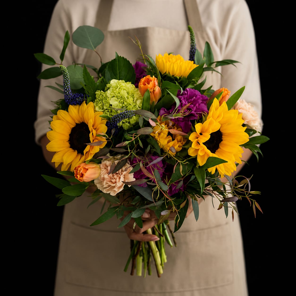 Signature Summer Designer's Choice - Let our designers create a beautifully curated arrangement using the freshest blooms of the season. Each design is uniquely crafted with elegance, intention, and our signature touch.  Our Signature Designer’s Choice begins with a thoughtful, airy design, with options to upgrade to a fuller and more abundant arrangement.   Our Deluxe option offers a more enhanced, lush presentation.  Our Premium option is our most popular, featuring a fuller, more luxurious design with added blooms and texture.  Perfect for any occasion when you want something beautiful, meaningful, and unforgettable.  Vase included.   
