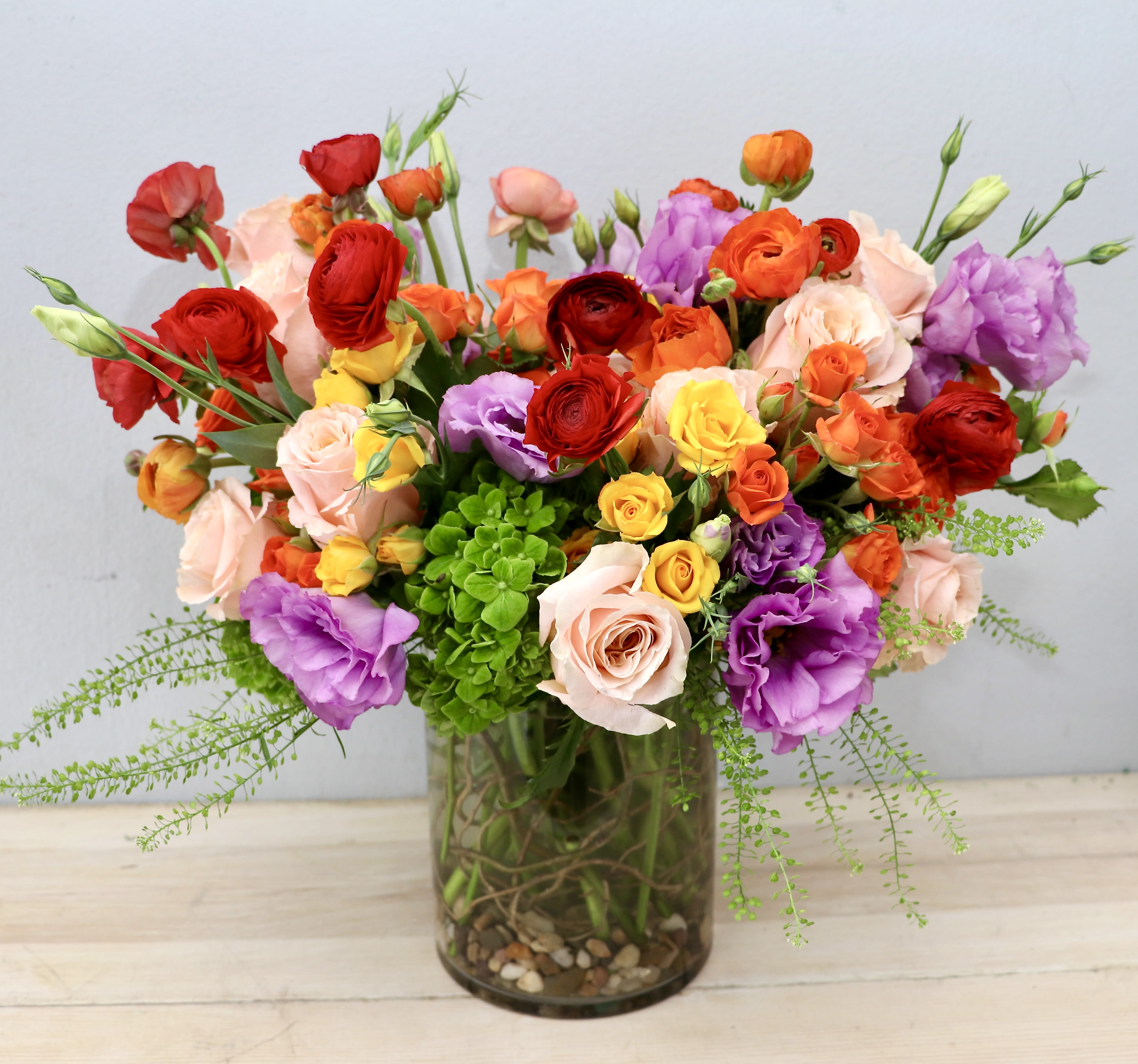 Summer Sunset - Glendale Flowers - Brighten up any room with our Summer Sunset arrangement. We choose a mix of colorful, seasonal flowers like tulips, roses, and hydrangeas. Standard size stands at 10-12 inches tall and wide. Upgrade if you'd like to have even more flowers and bring summer into your home!
