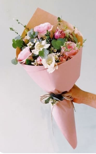 Pink and white bouquet wrapped in pastel paper