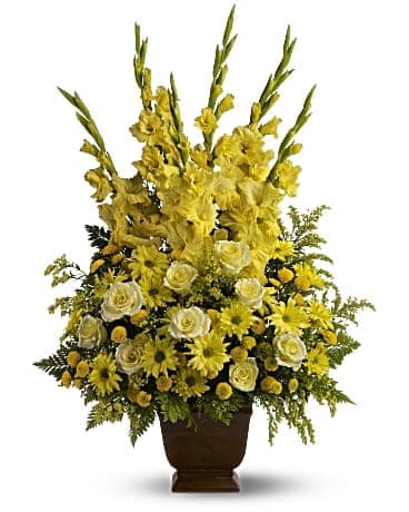 Sunny Memories - Celebrate your sunny memories of someone special with this tall funeral floral arrangement, presented in a graceful urn. The sunny yellow flowers are a classic statement of never-ending friendship and love. #kissimmeesympathy #sympathy #kissimmeefuneral
