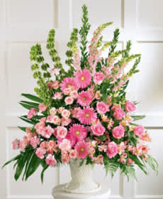 Splendid Grace - Pink is always a wonderful color to recognize a lady important in your life. This urn is over flowing with a variety of pink flowers. This make a wonderful statement on a pedestal or the floor.