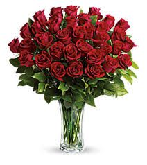 36 Roses Vased - A lush, rounded bouquet of 36 roses in a clear glass vase makes a timeless romantic statement - perfect as an anniversary roses arrangement, Valentine's Day surprise, or a birthday bouquet for the person you adore. The dense cluster of deep red roses against glossy green foliage reads classic and formal, the kind of gift that makes someone feel truly cherished and celebrated.