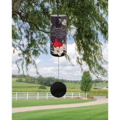 Hanging memorial wind chime with floral accents outdoors