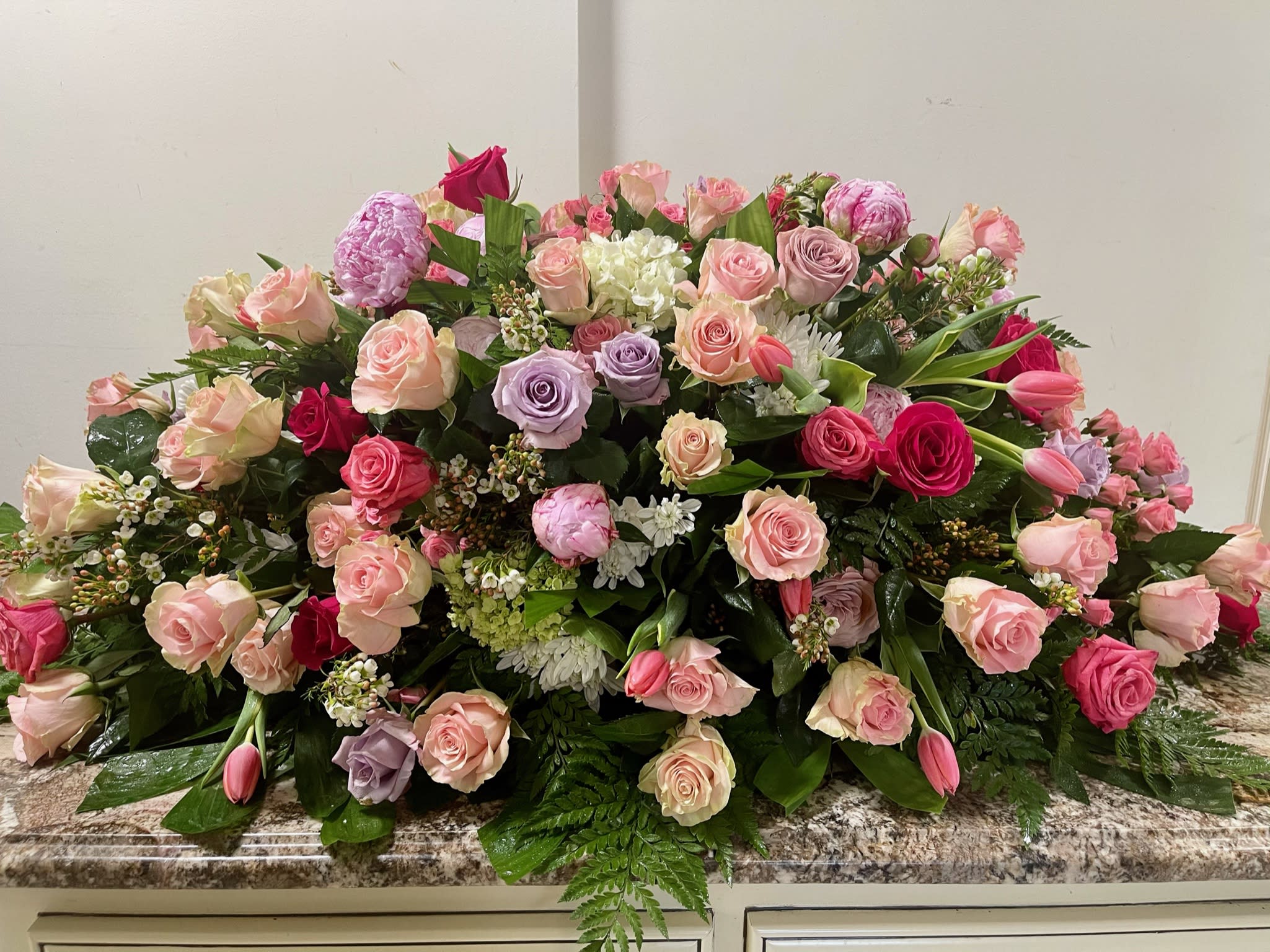 Large mixed bouquet of pink, lavender, and white roses with tulips