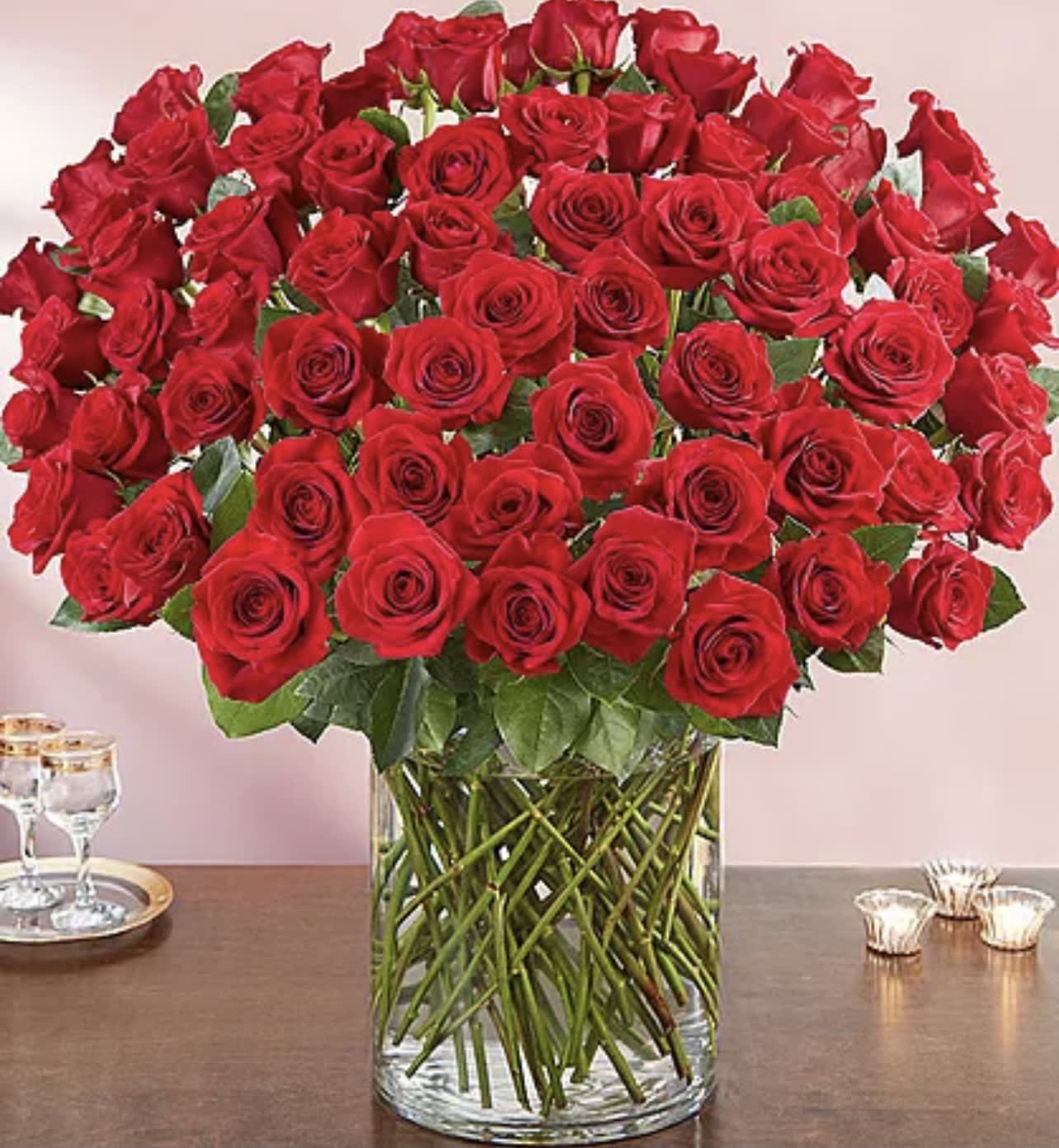 Large bouquet of red roses in a clear glass vase