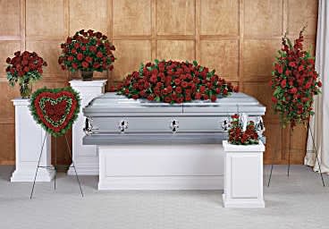Red rose funeral casket spray with matching standing arrangements