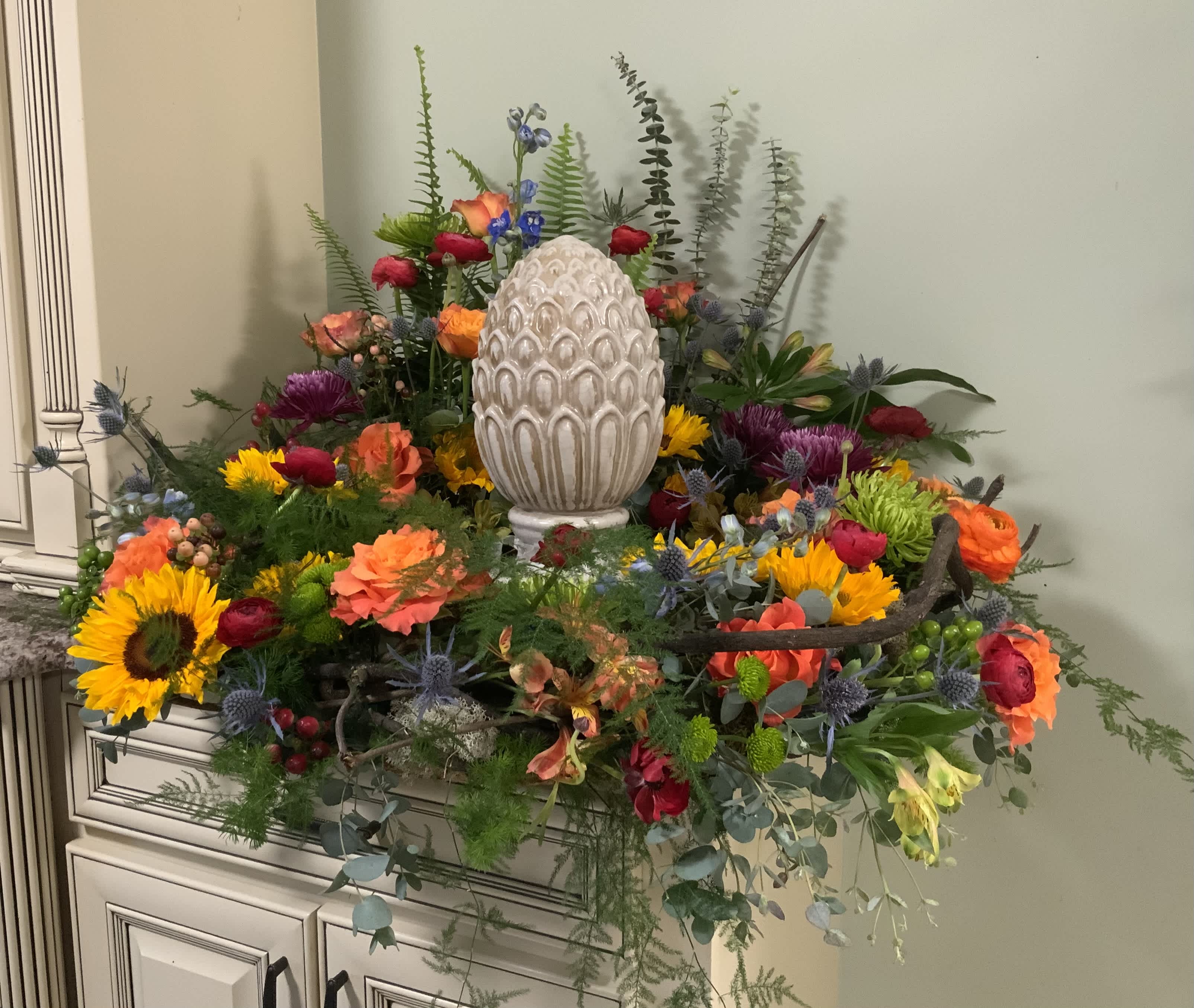 Colorful floral arrangement with a decorative white egg centerpiece