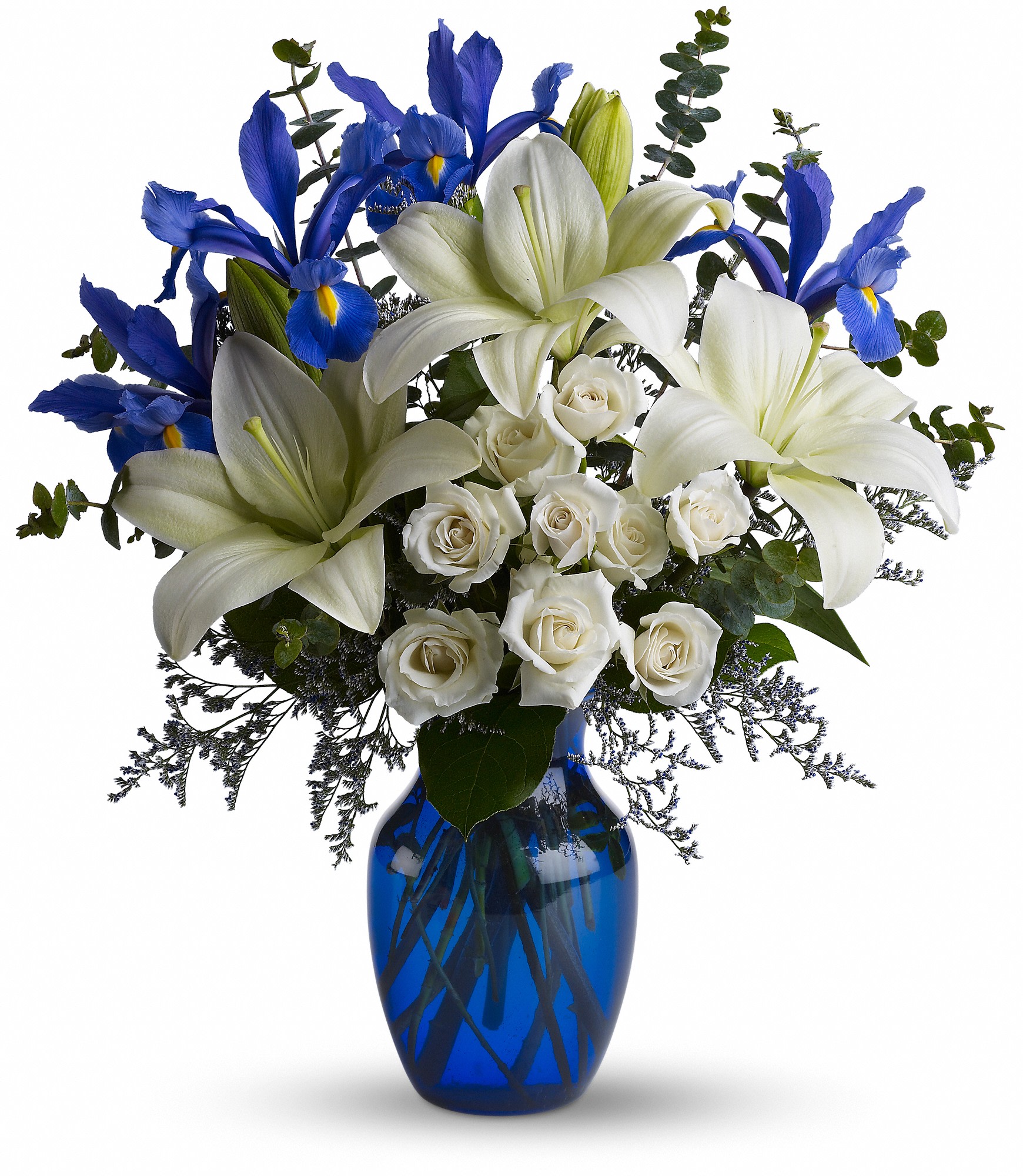 White lilies and roses with blue irises in a cobalt vase