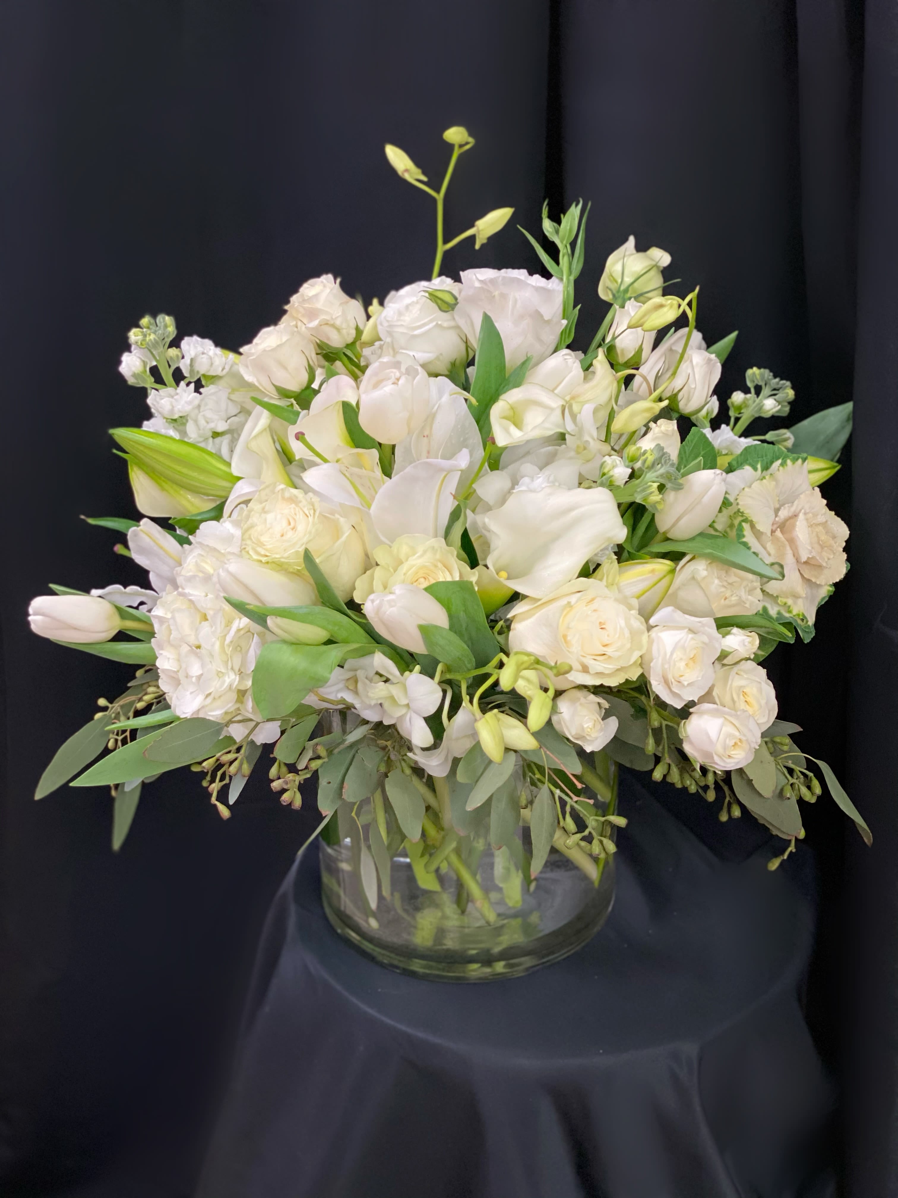 White floral arrangement in a clear glass vase