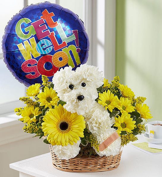 White teddy bear in a basket with yellow flowers and a "Get Well Soon!" balloon