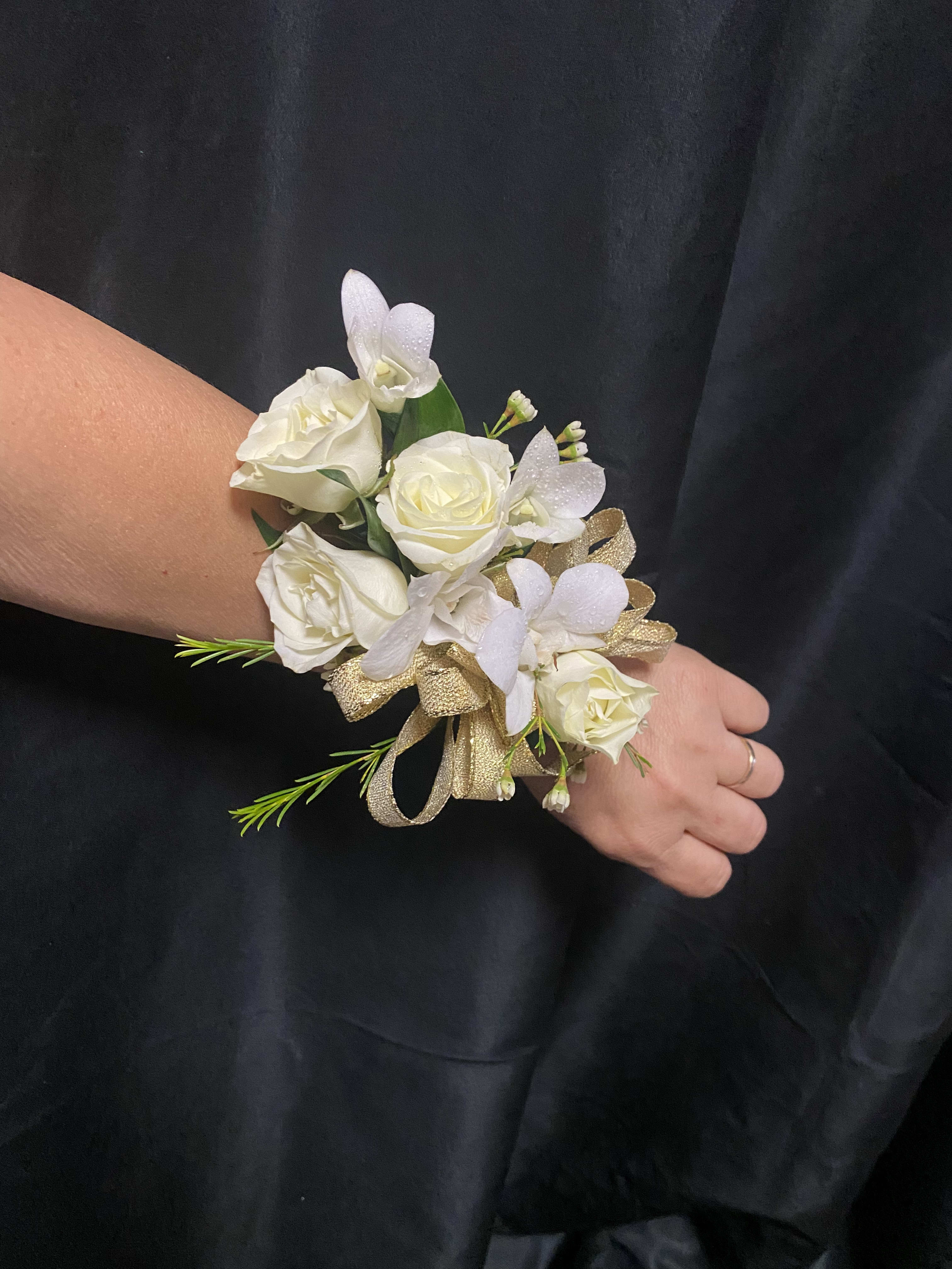 White rose wrist corsage with small white orchids and gold ribbon
