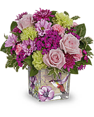 Pink and purple mixed bouquet in a square glass vase with a bird design