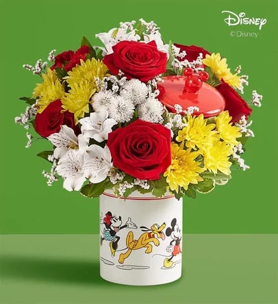 Bouquet of red roses, white lilies, and yellow chrysanthemums in a Disney tin