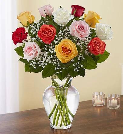 Bouquet of multicolored roses in a clear glass vase