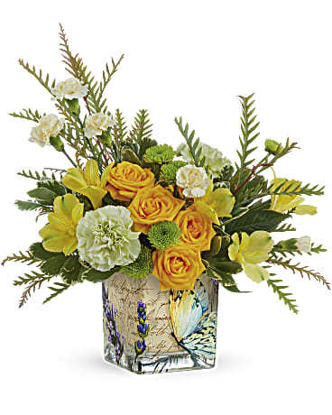 Yellow roses and carnations in a butterfly-patterned glass vase