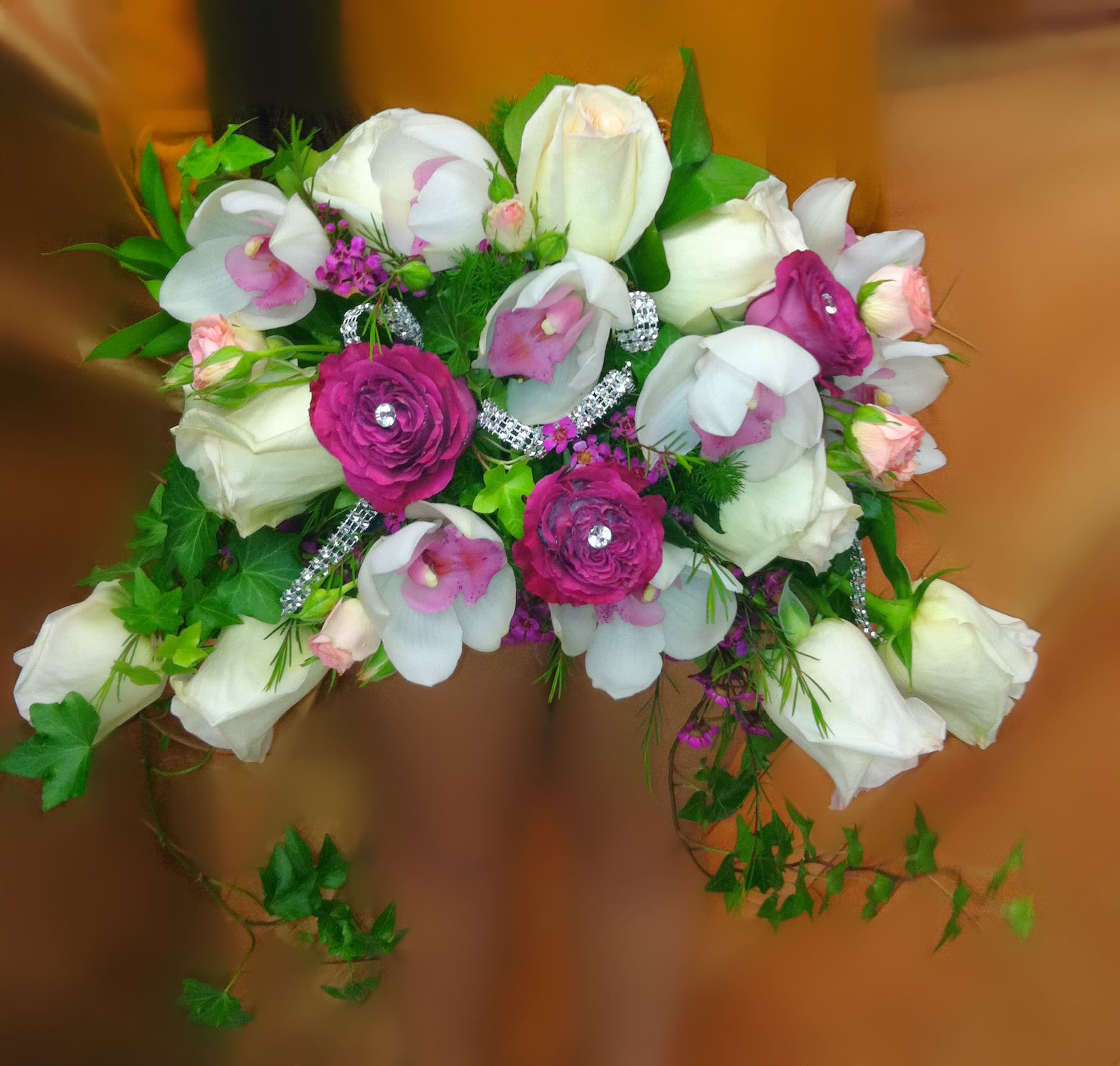 Bouquet of white and pink flowers with trailing greenery