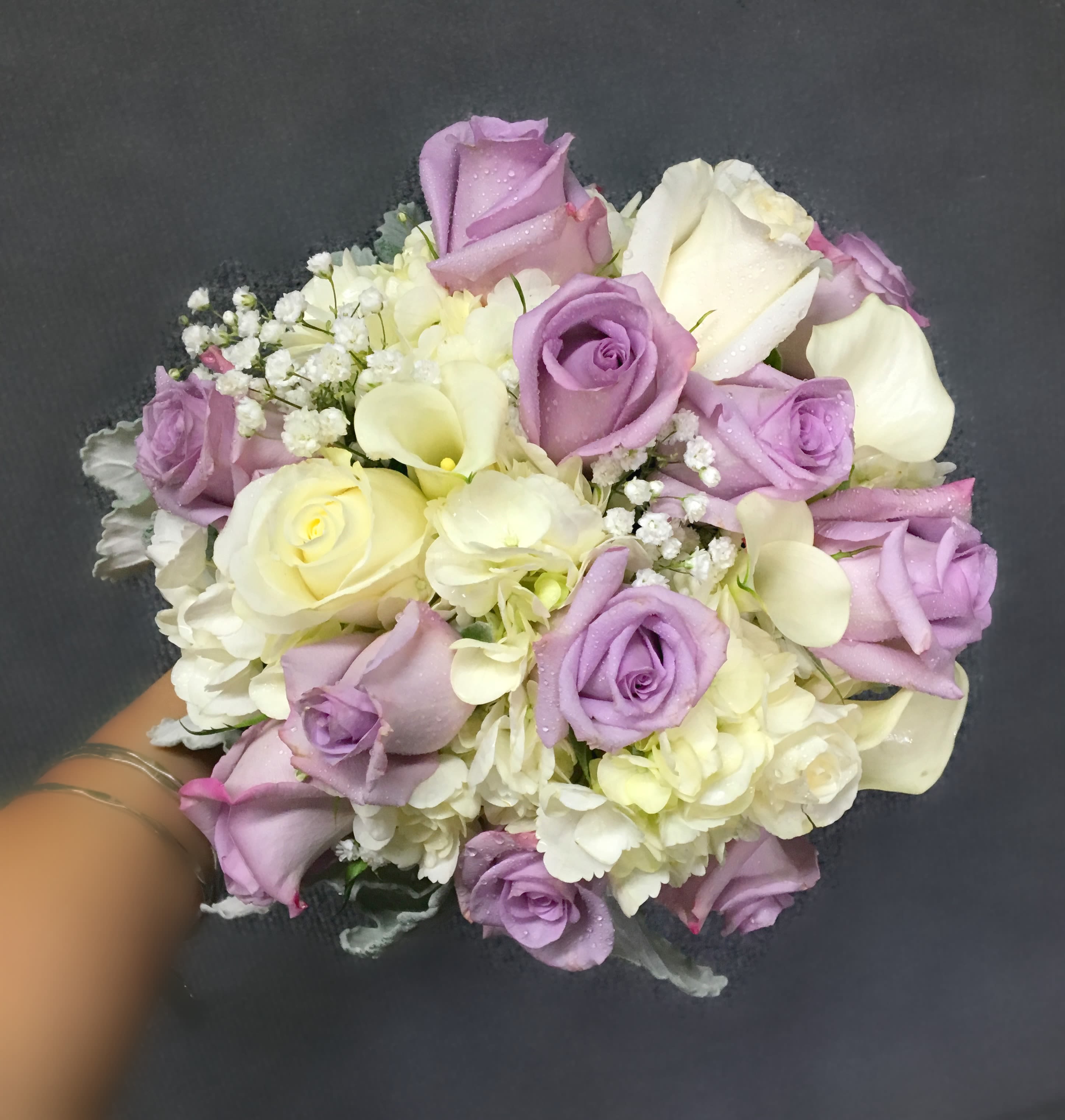 Bouquet of lavender and white roses with white filler flowers