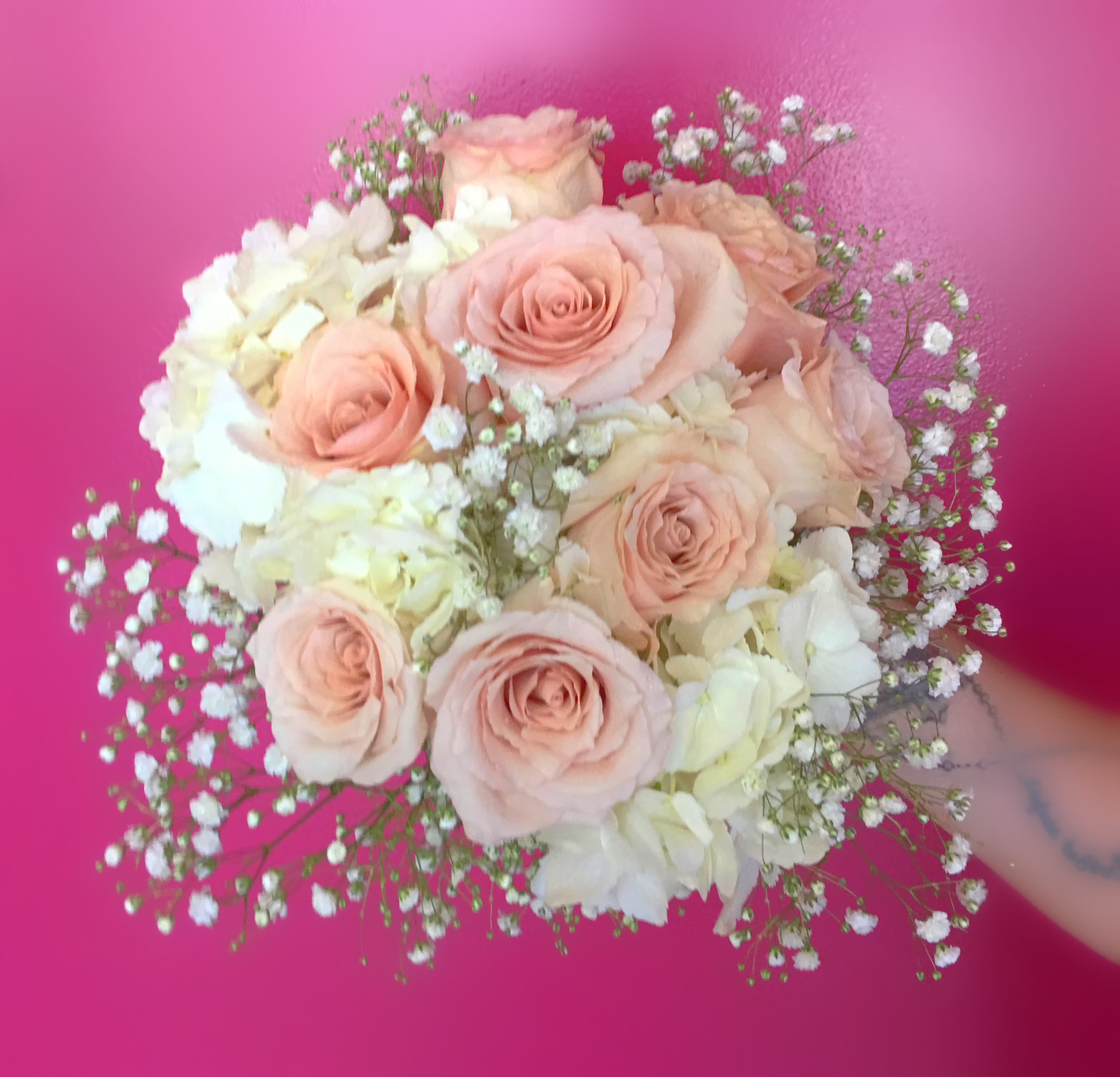 Blush roses and white hydrangeas in a round bouquet
