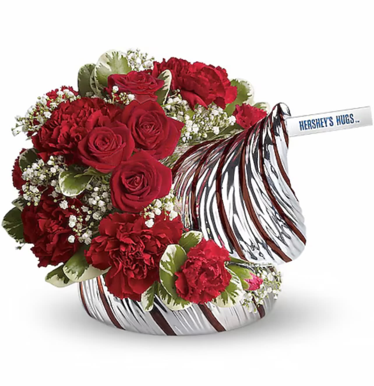 Red roses and carnations in a candy-shaped container with a Hershey's Hugs bar
