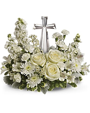 White floral wreath with a silver cross centerpiece
