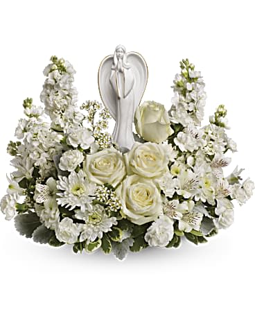 White floral arrangement with a praying angel figurine