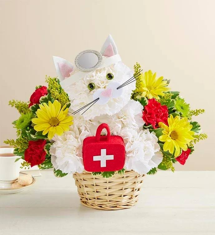 Cat-shaped flower basket with white, red, and yellow blooms