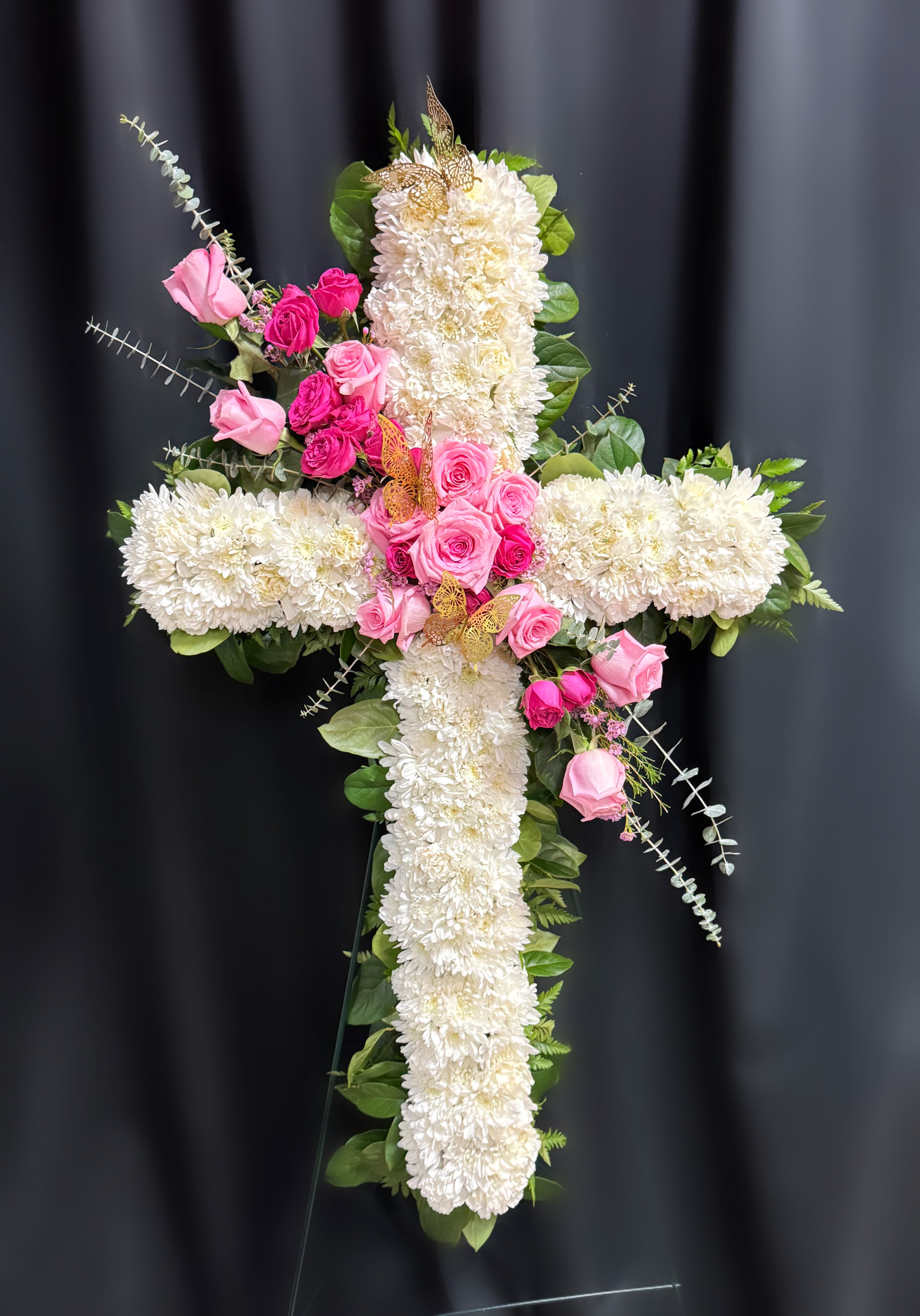 Cross-shaped floral arrangement with white chrysanthemums and pink roses