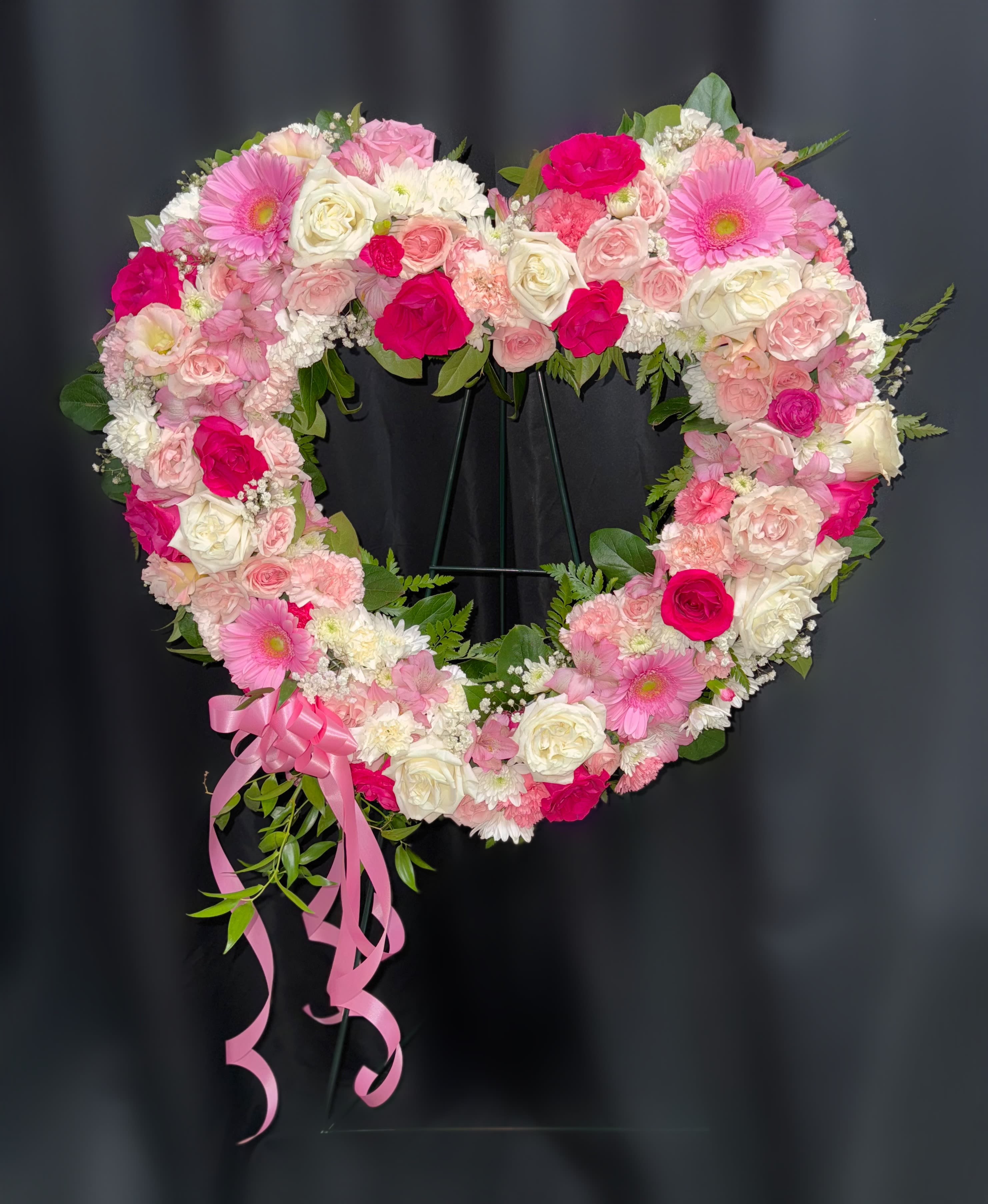 Heart-shaped floral wreath with pink and white roses and gerbera daisies