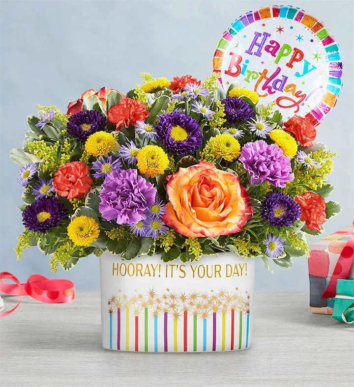 Colorful mixed flower arrangement in a birthday gift box with a balloon