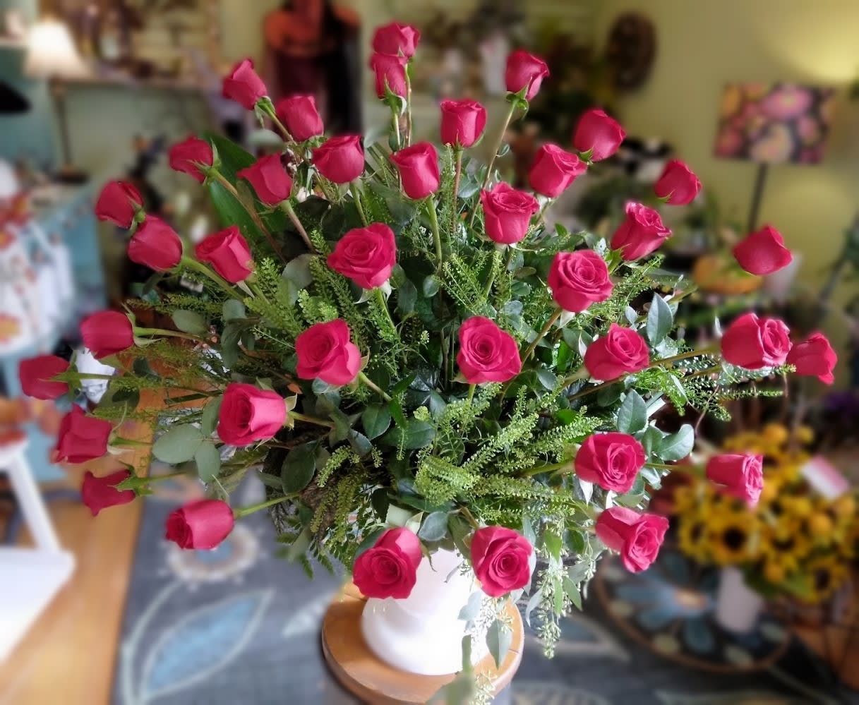 Bouquet of hot pink roses in a white vase