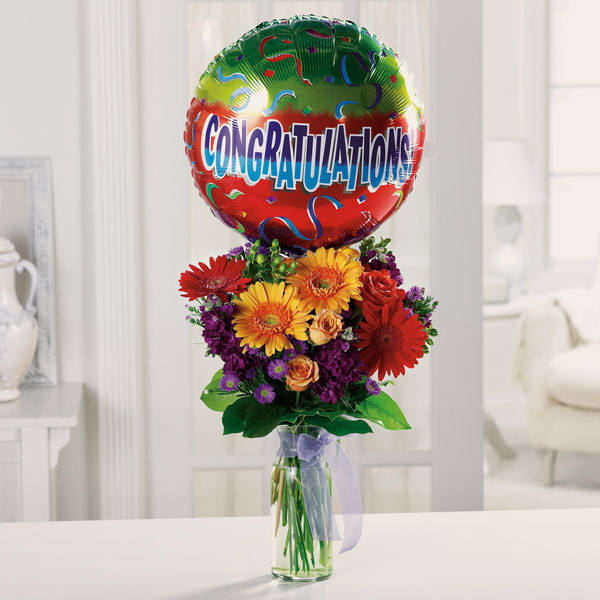 Hooray For You! - Celebrate any grand accomplishment with this grand bouquet of roses, Gerbera daisies, larkspur and hypericum, topped with a Congratulations balloon! The arrangement in photo shows the size and variety of flowers that the arrangement will have. Colors/ flowers WILL vary. Balloon can change upon request in special notes section. 
