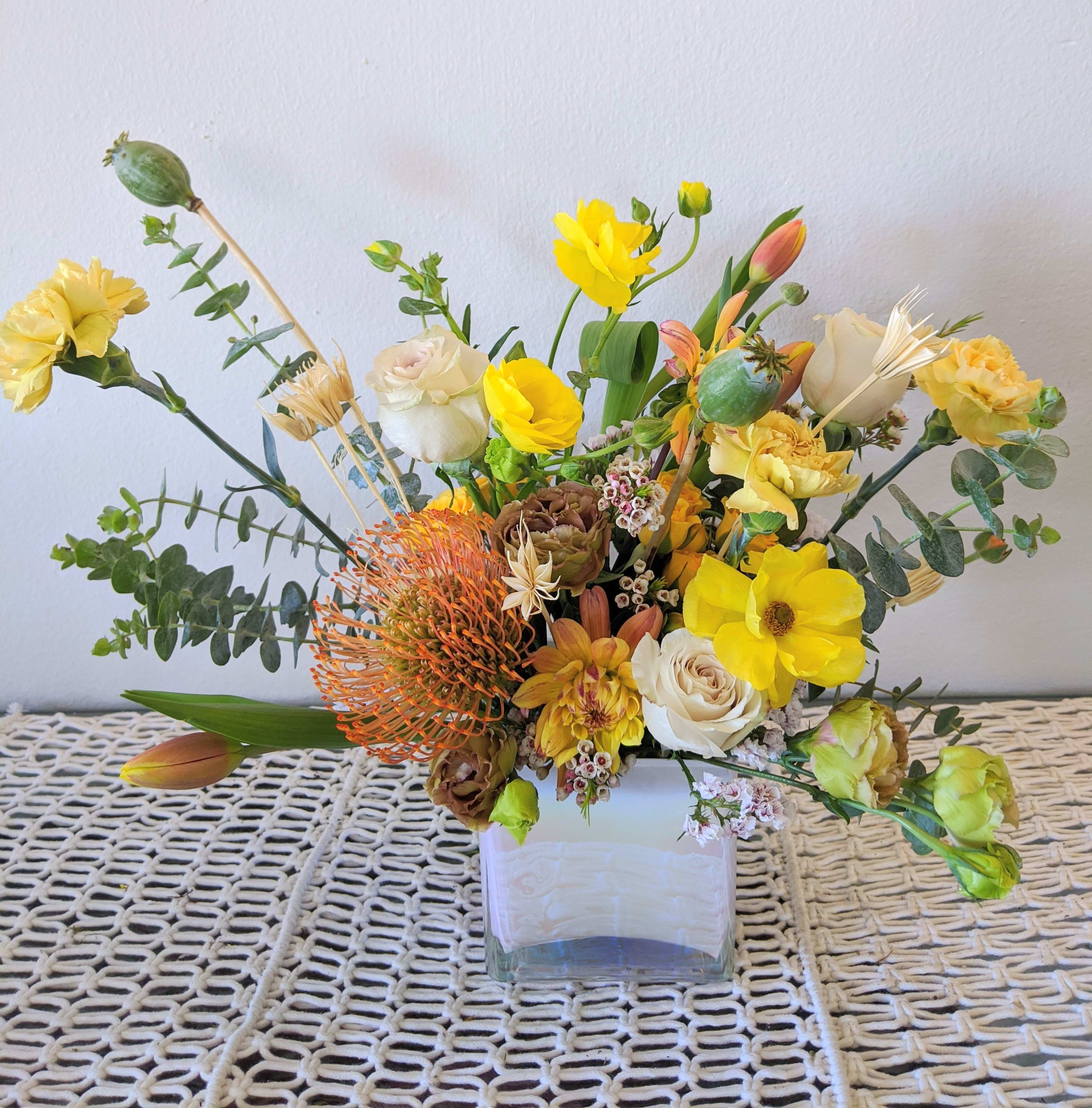 You're My Light - A bright and cheerful assortment with yellows and oranges in a iridiscent square vase. 