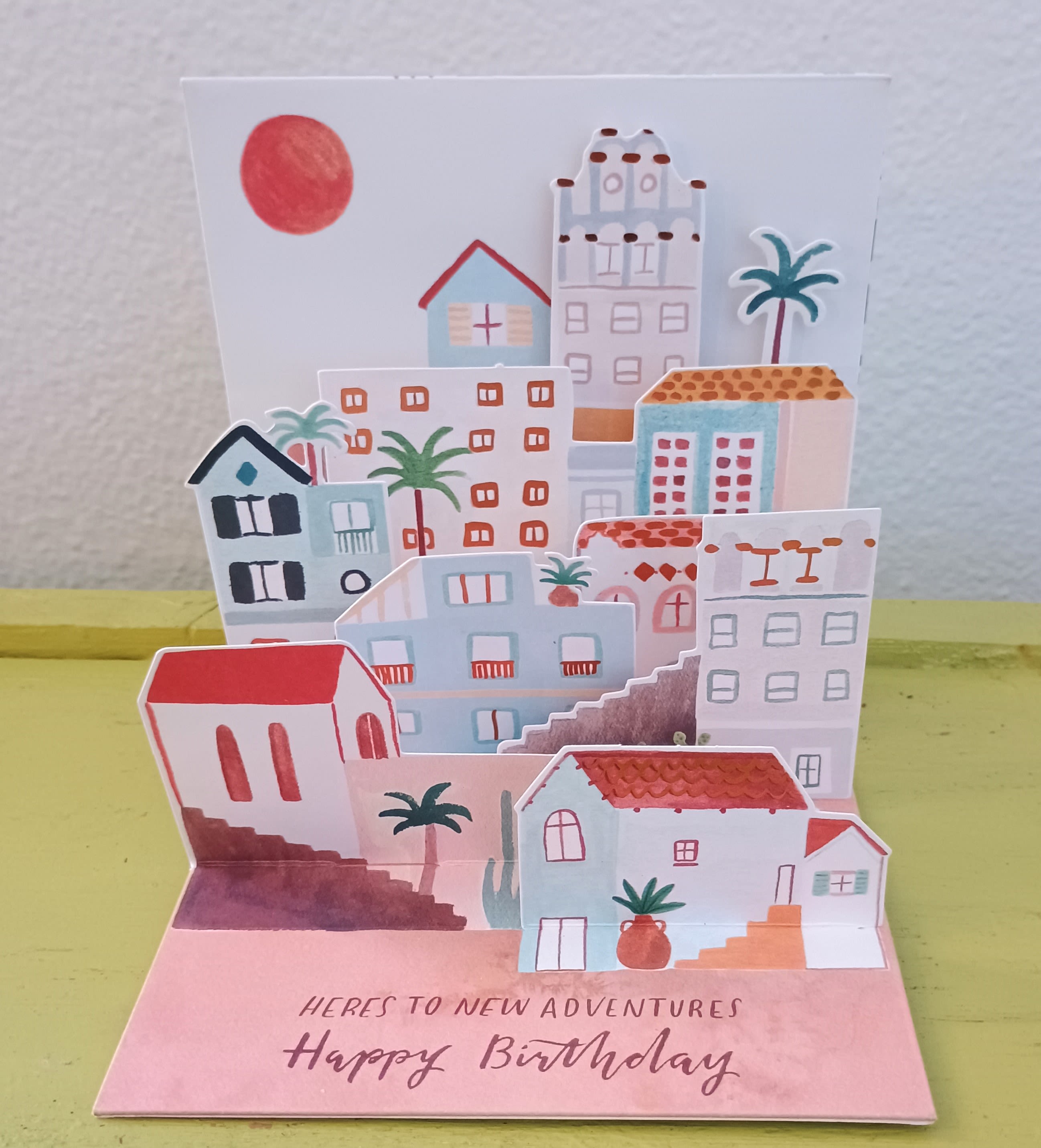 Pop-up birthday card with colorful houses and palm trees