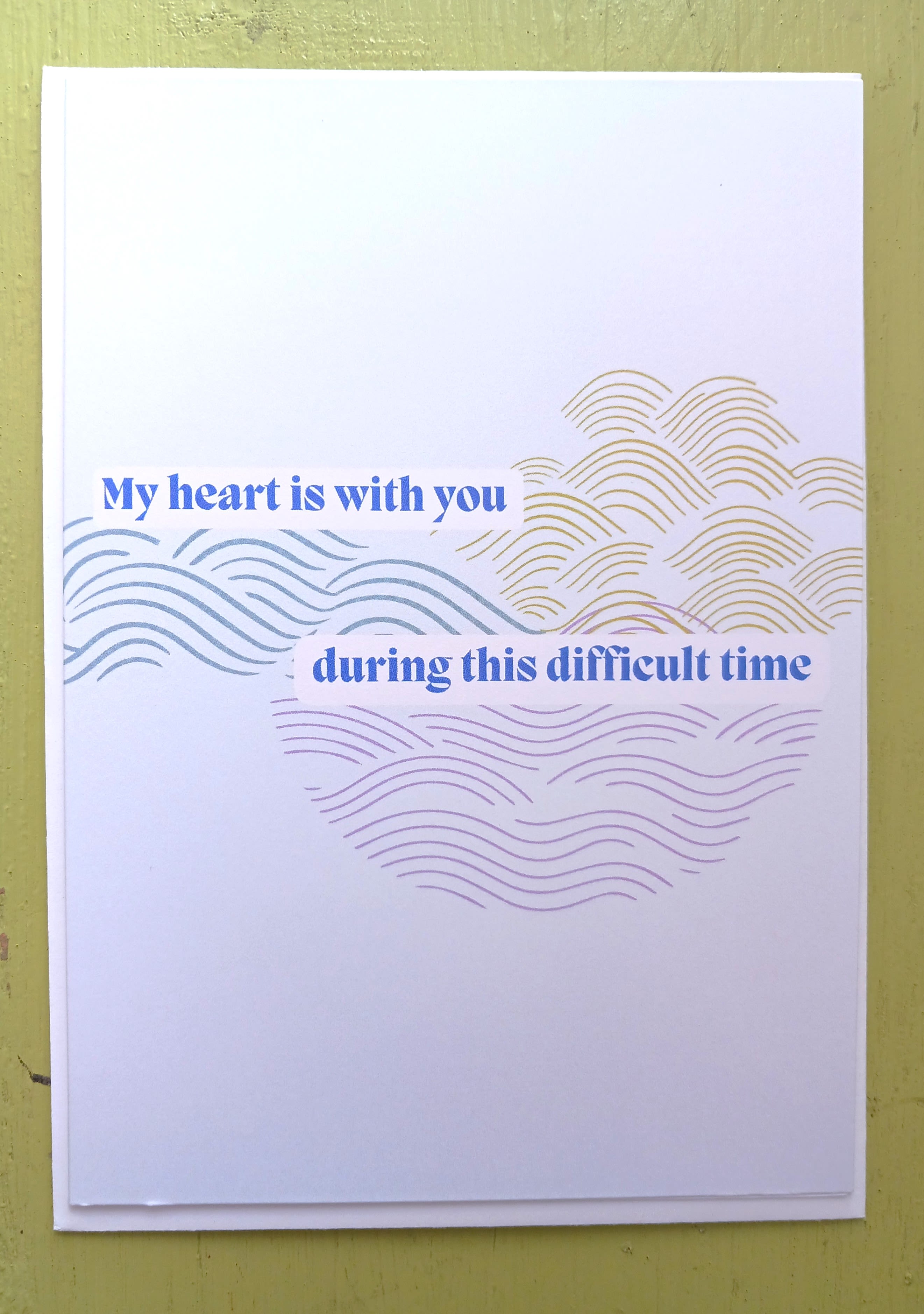 Sympathy greeting card with blue text and abstract wave patterns in soft colors