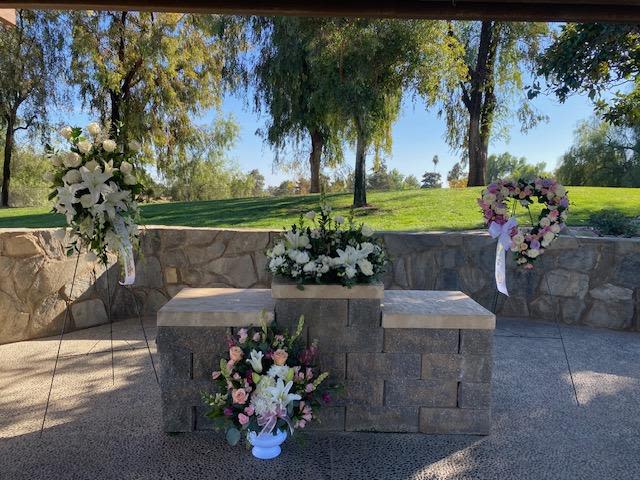 Memories for a Lifetime Mixed Set - This option is a mixed floral set for your loved ones funeral service. Included will be 2 standing sprays, 1 tall one sided urn, and 1 floral ring for an urn or wooden box. Specific colors can be requested at no additional charge. *Substitutions can be made as well, please make notes in special instructions box* 