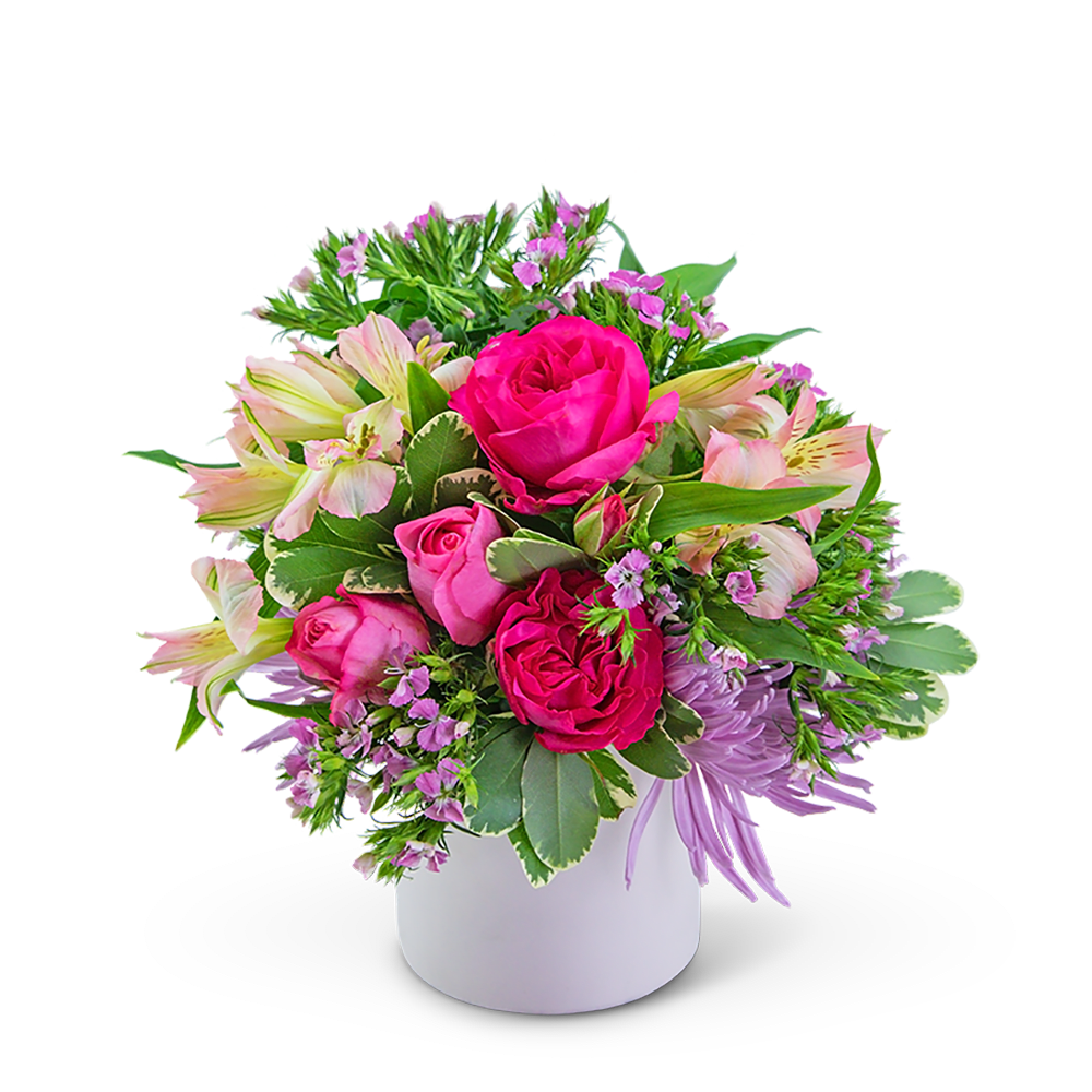 Pink roses and pale lilies arranged in a white vase
