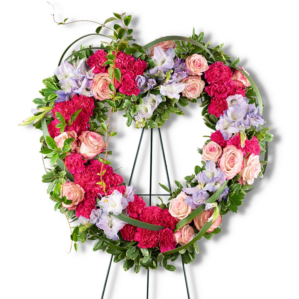 Heart-shaped floral wreath with pink roses, carnations, and lavender flowers
