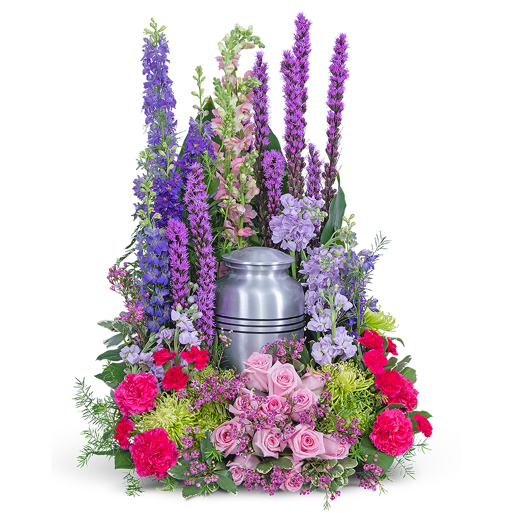 Colorful funeral urn arrangement with pink roses and tall purple flowers