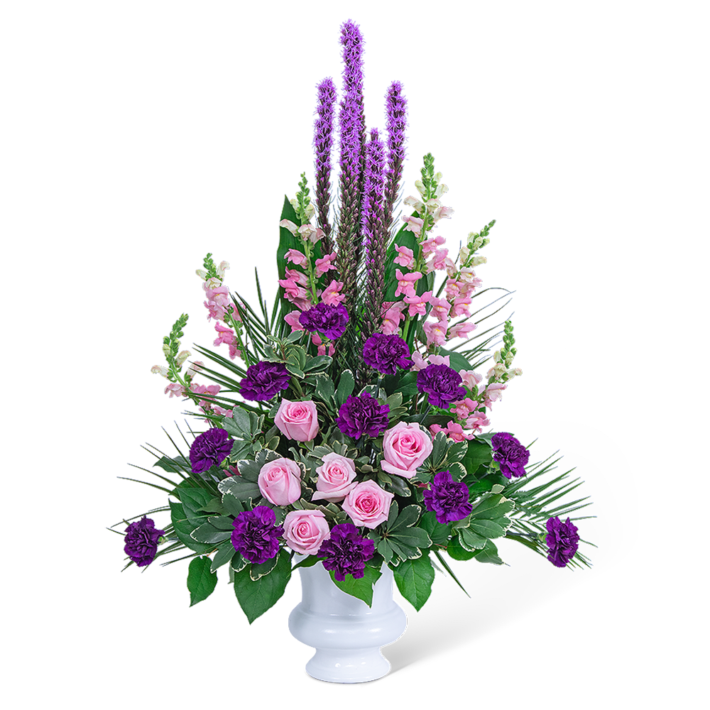 Pink roses and purple flowers arranged in a white vase