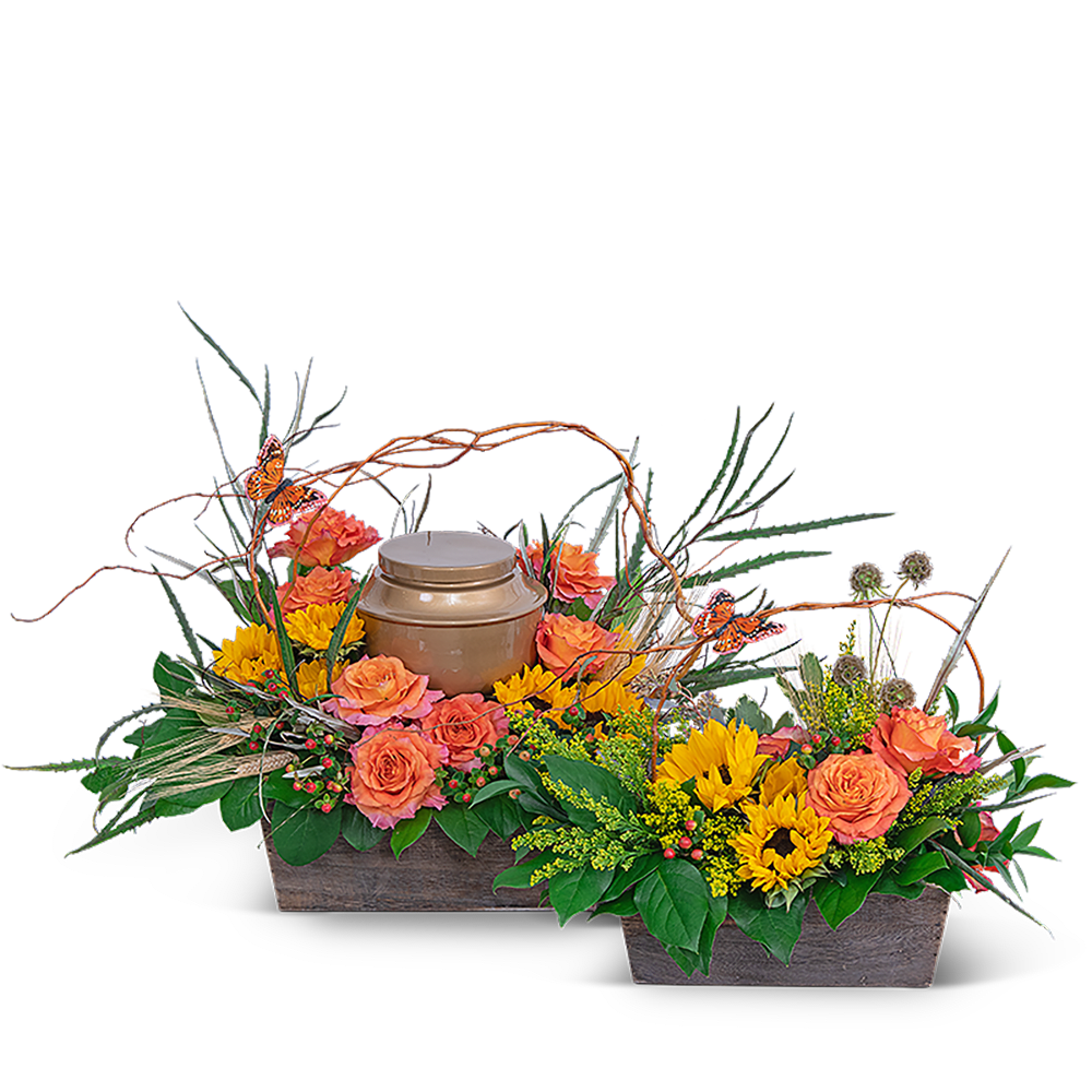 Two floral basket arrangements with orange roses and yellow sunflowers around a urn