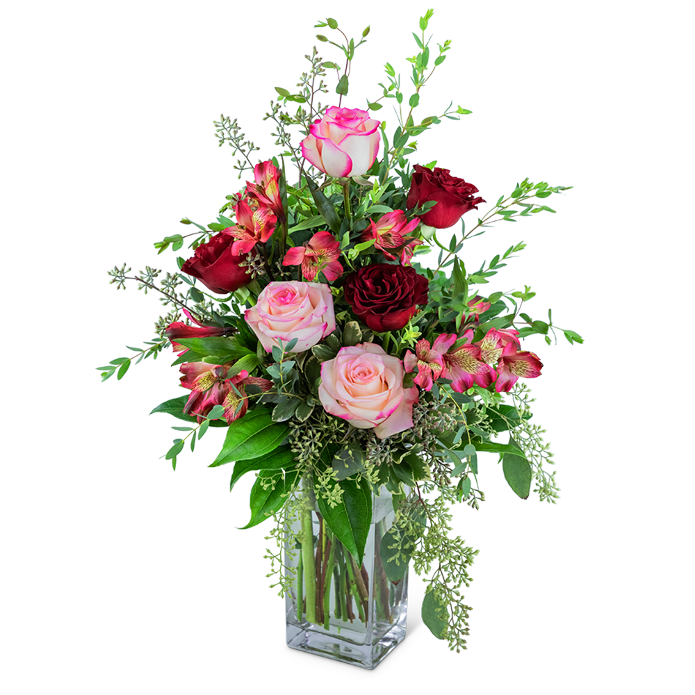 Bouquet of pink and red roses in a clear glass vase