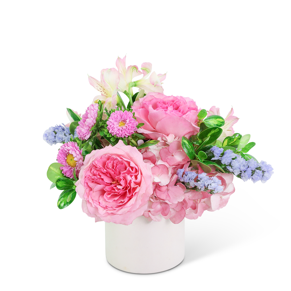 Pink and lavender flower arrangement in a white vase