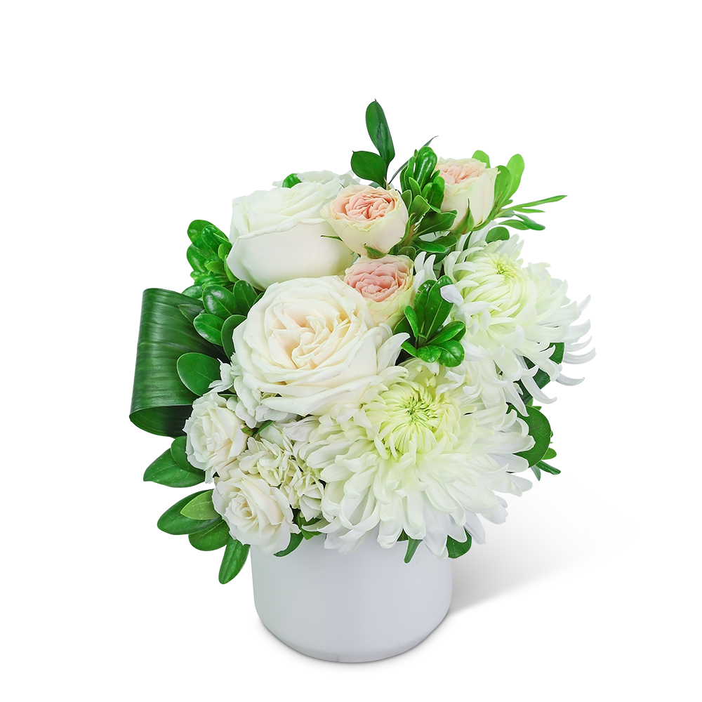 White and blush roses with white chrysanthemums in a white vase