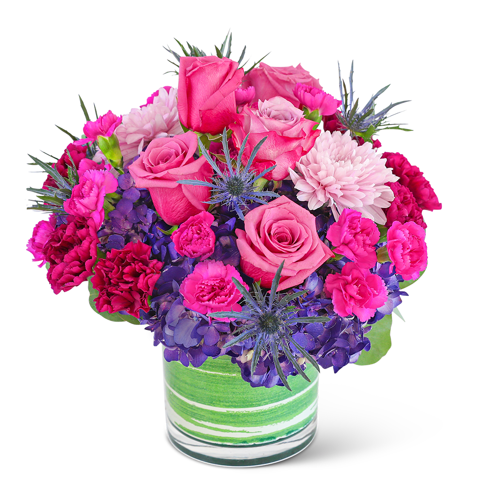 London Luxe - Delight in the rich purple tones of one of our floral favorites, London Luxe. A chic, leaf-lined vase with hydrangea, roses, carnations, and premium foliage makes up this luxe floral design. This vibrant flower arrangement will brighten anyone's day and add a pop of color to any space.