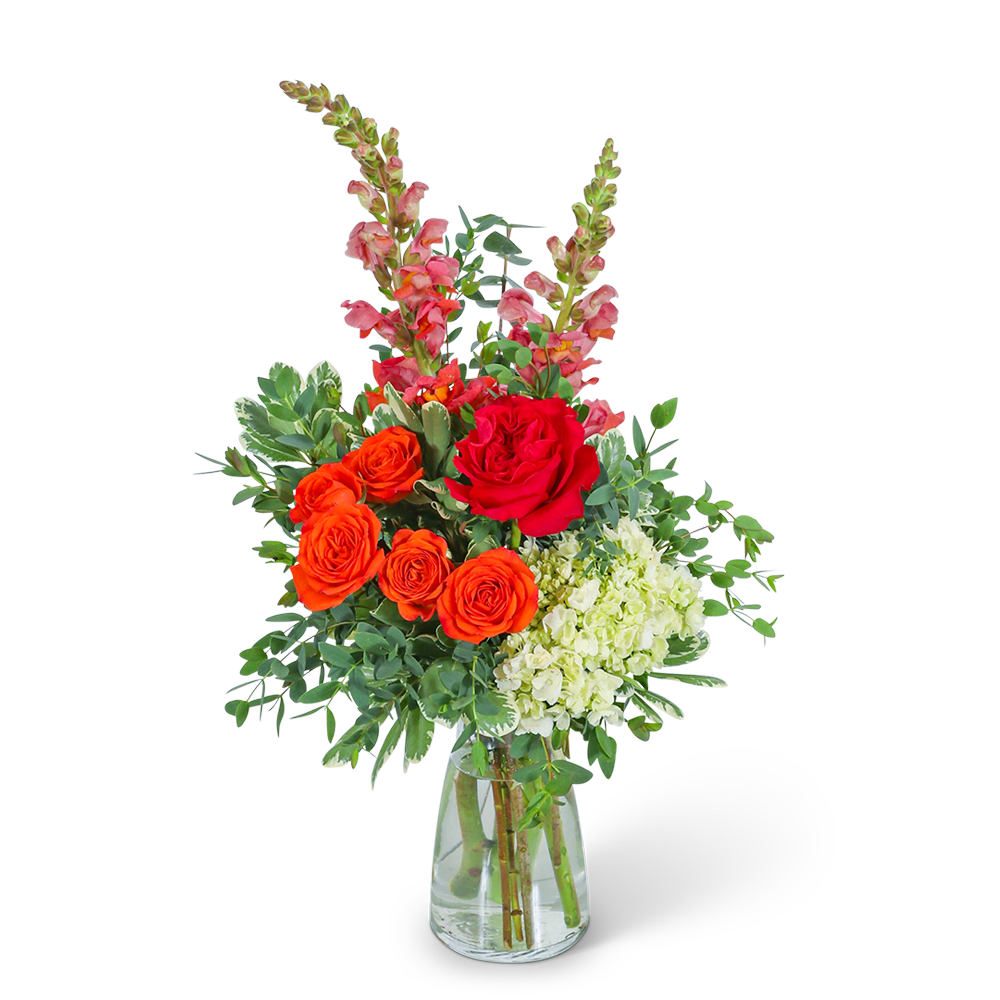 Bouquet of orange and red roses with pink snapdragons in a glass vase