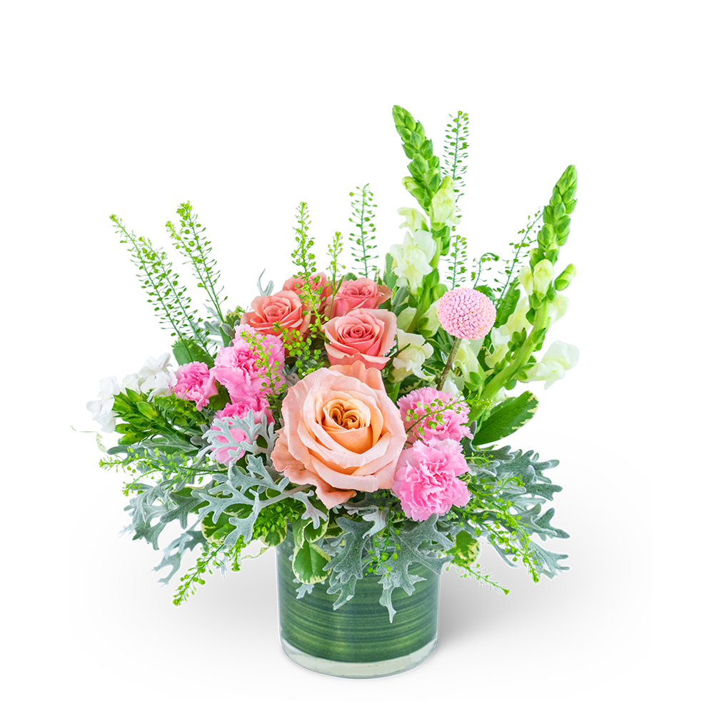 Pink and peach roses with carnations in a green glass vase